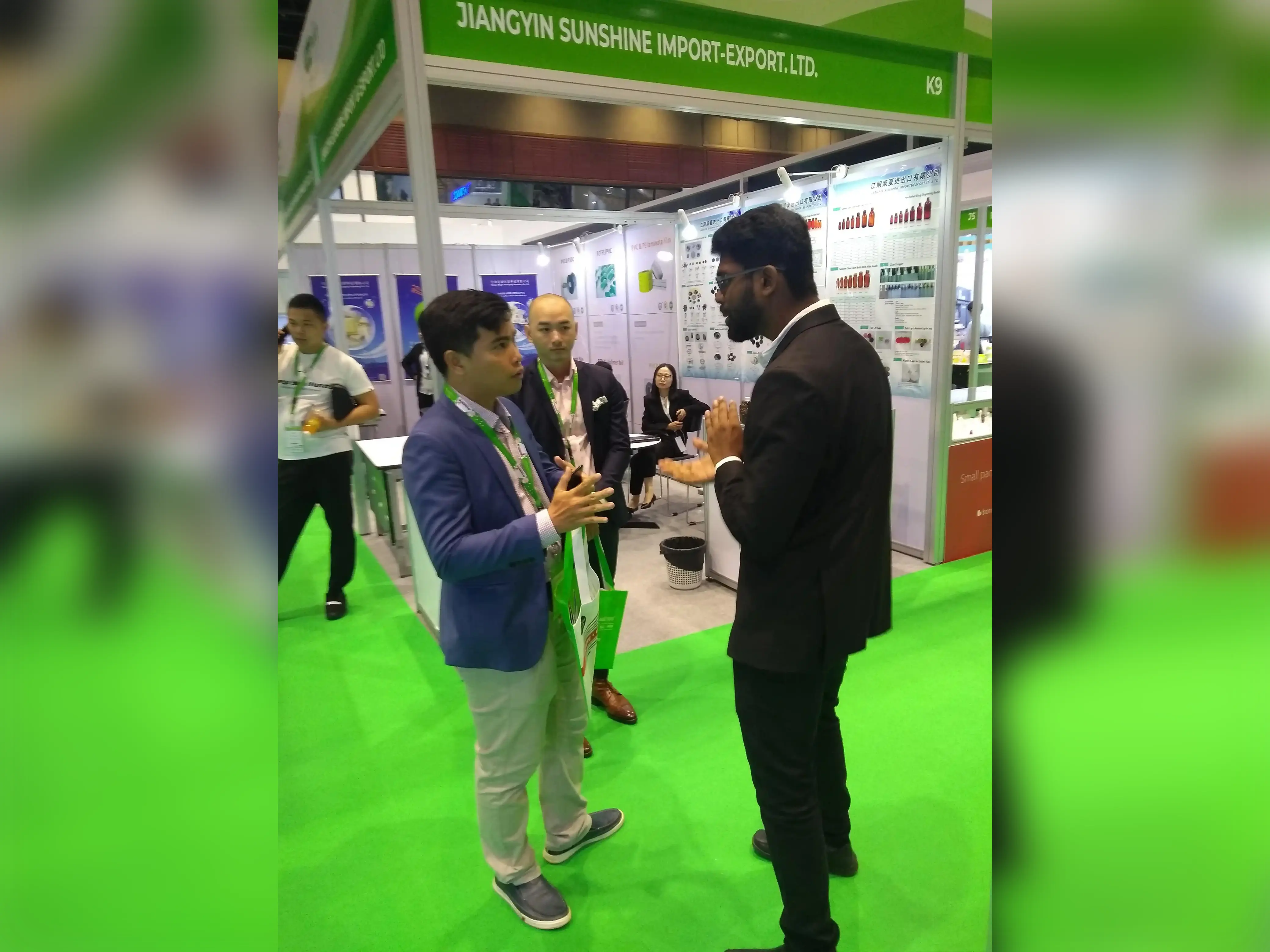 Two men discussing at the SANeForce exhibition stand during CPHI, held in Bangkok, Thailand, from March 12 to 14, 2019.